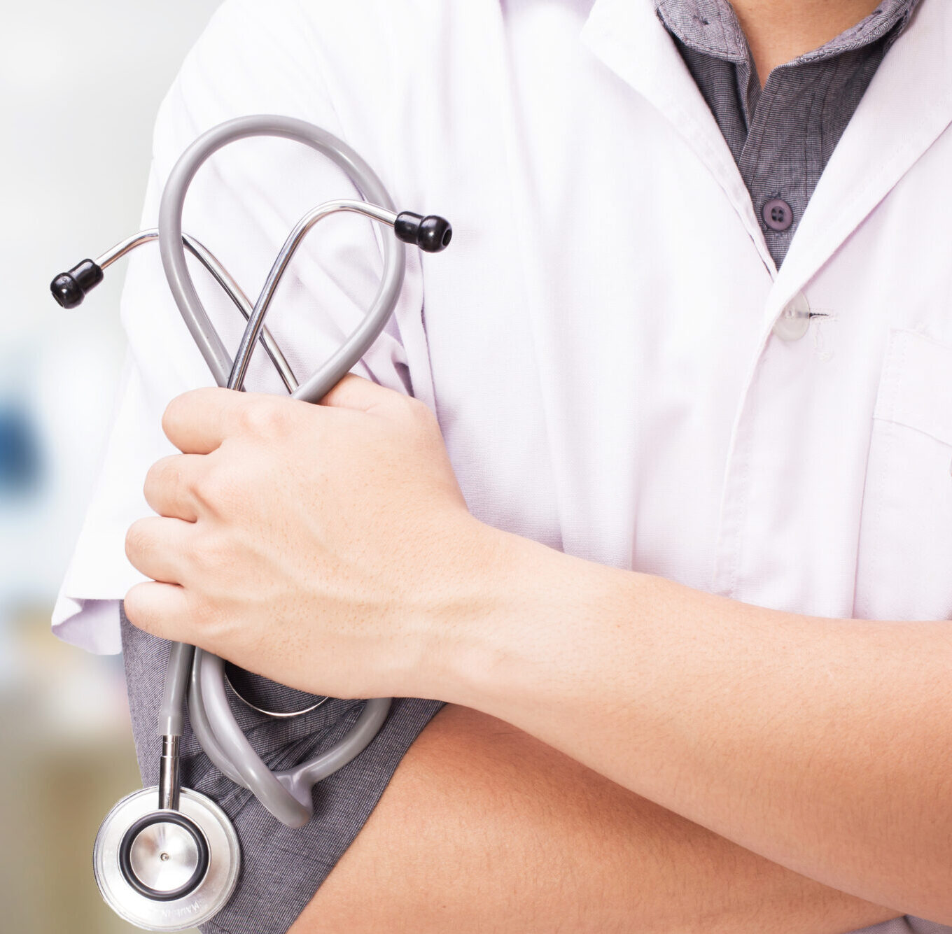 doctor with a stethoscope in the hands and hospital background